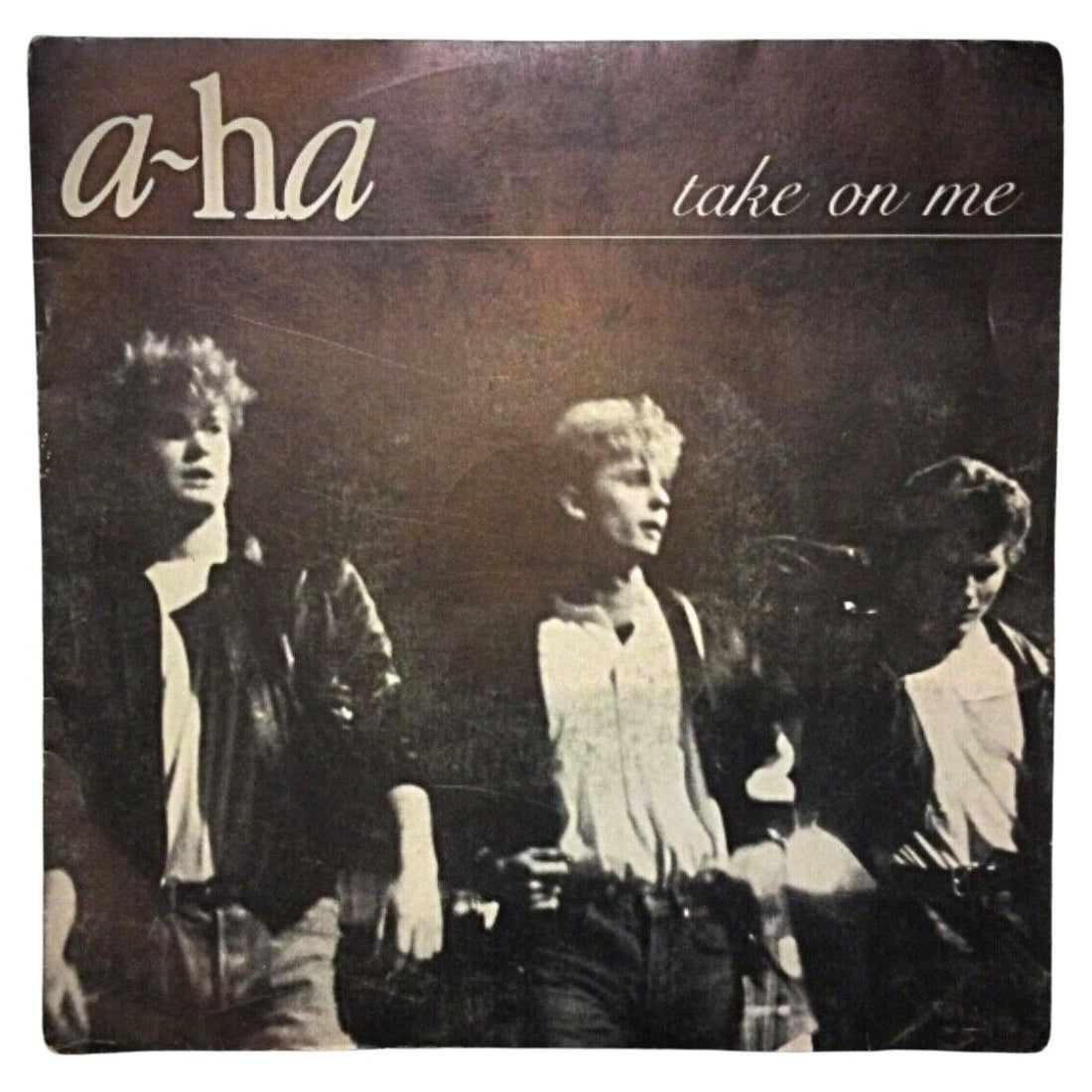 A-Ha 'Take on Me' 45 RPM vinyl record cover featuring the iconic band photo from the 1980s.