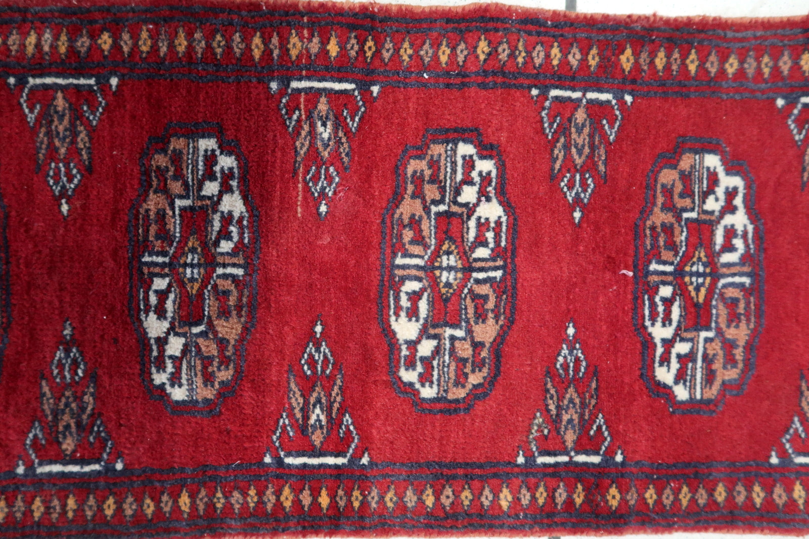 Texture Close-up of Deep Red Base Color on Handmade Vintage Uzbek Bukhara Rug - 1960s