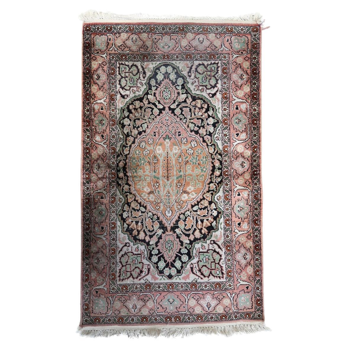 Handmade vintage Persian Tabriz silk rug with floral medallion design
