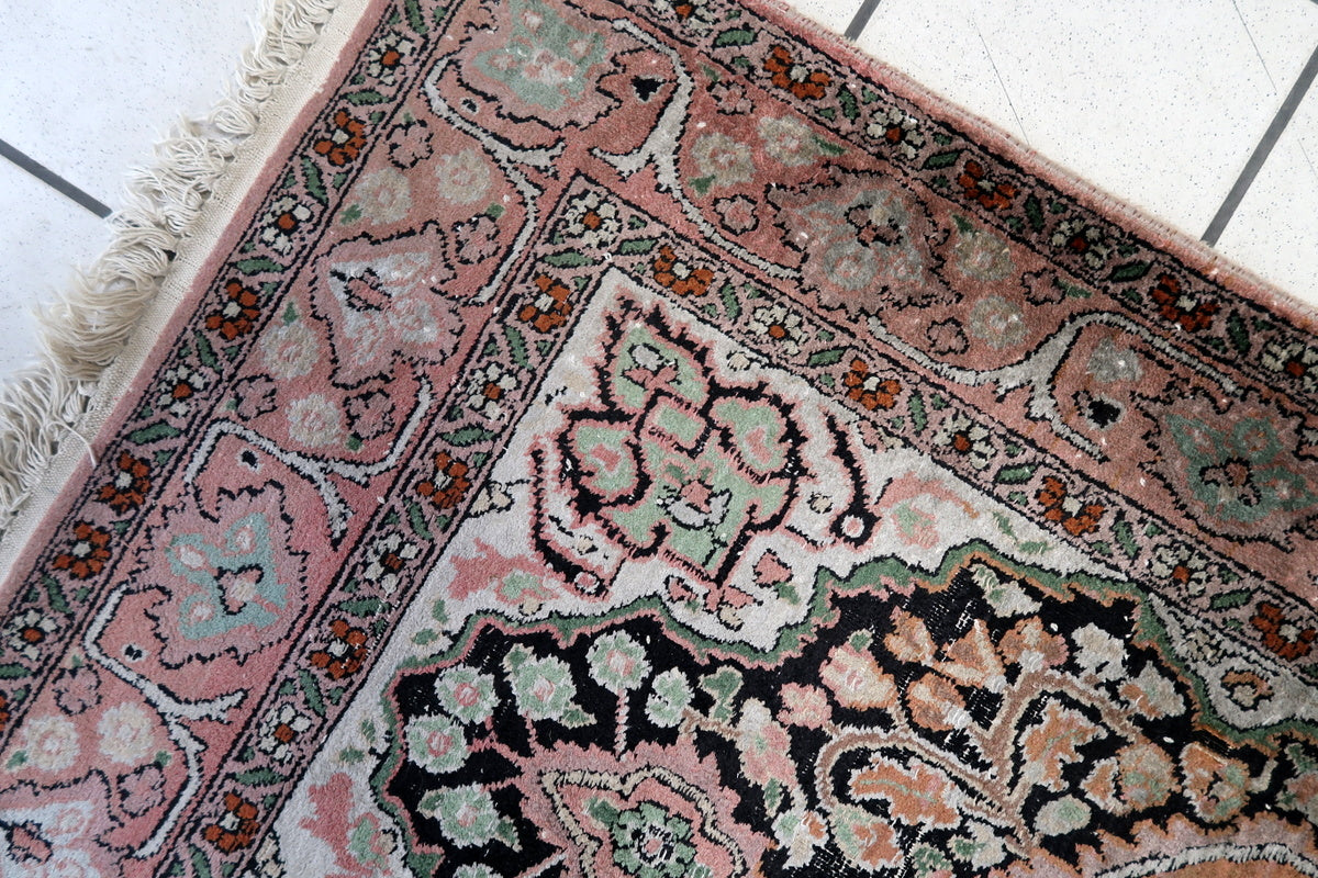 A detailed shot of the rug’s fringe, showing natural aging
