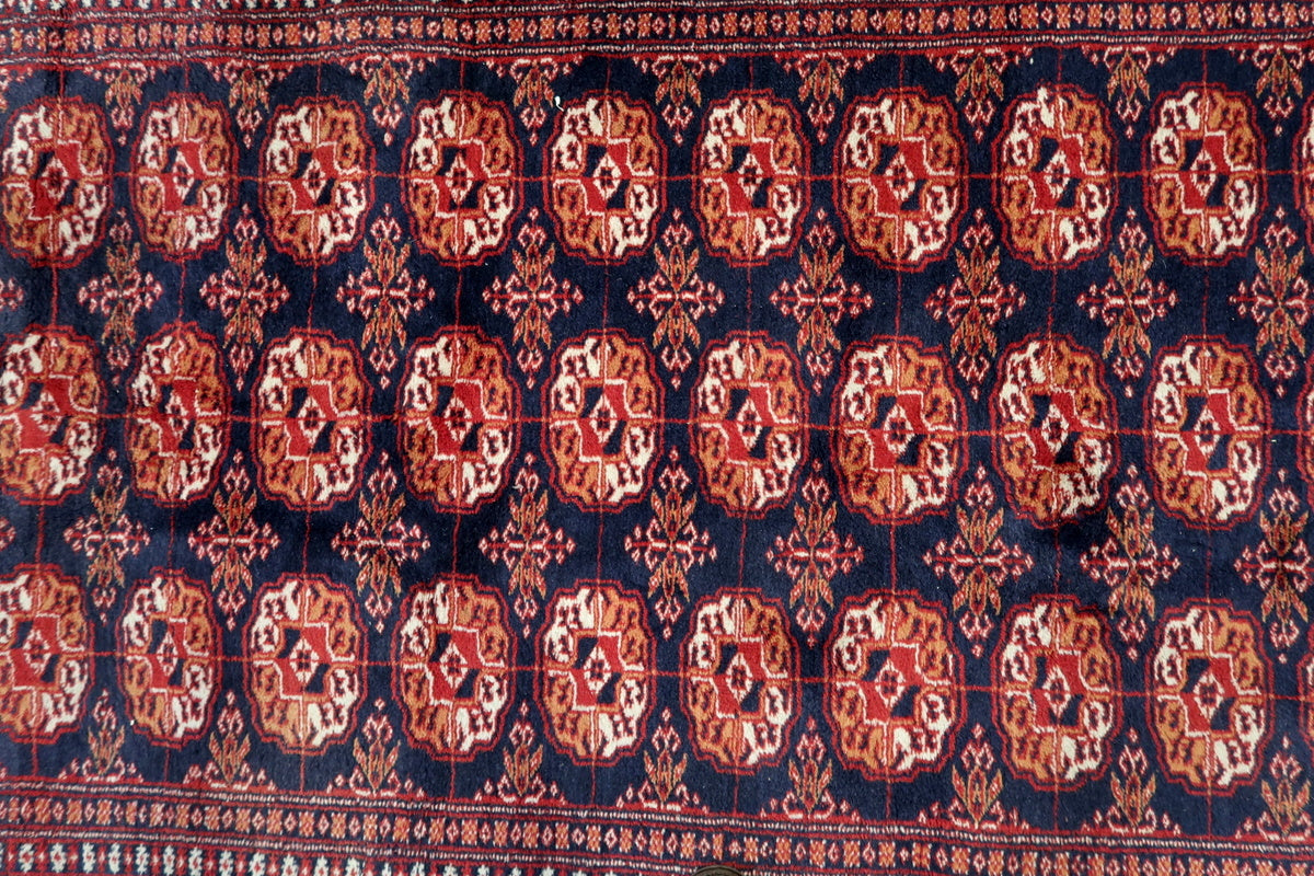 The Bukhara rug displayed in a modern living room, enhancing the decor
