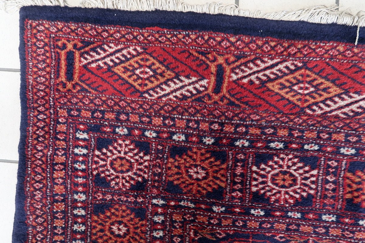 Close-up of the hand-knotted wool texture on this 1960s Bukhara rug
