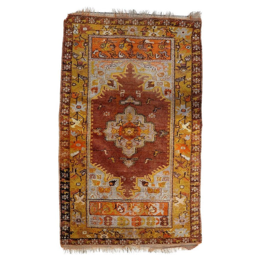 Handmade 1920s Turkish Anatolian rug with a central medallion and intricate tribal patterns
