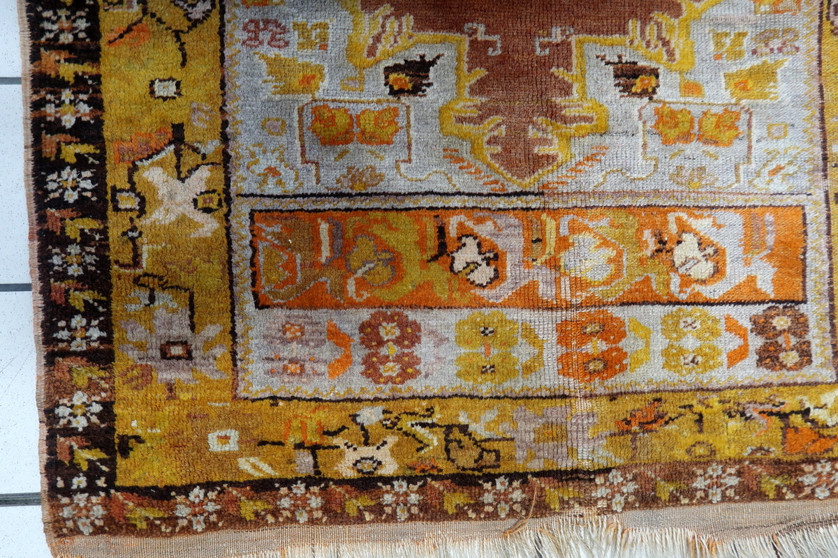 Close-up of the fine wool weave and natural patina of the antique Anatolian rug
