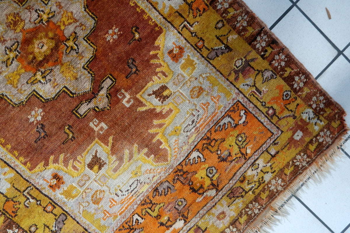 Symmetrical medallion design in the center of the vintage Turkish wool rug
