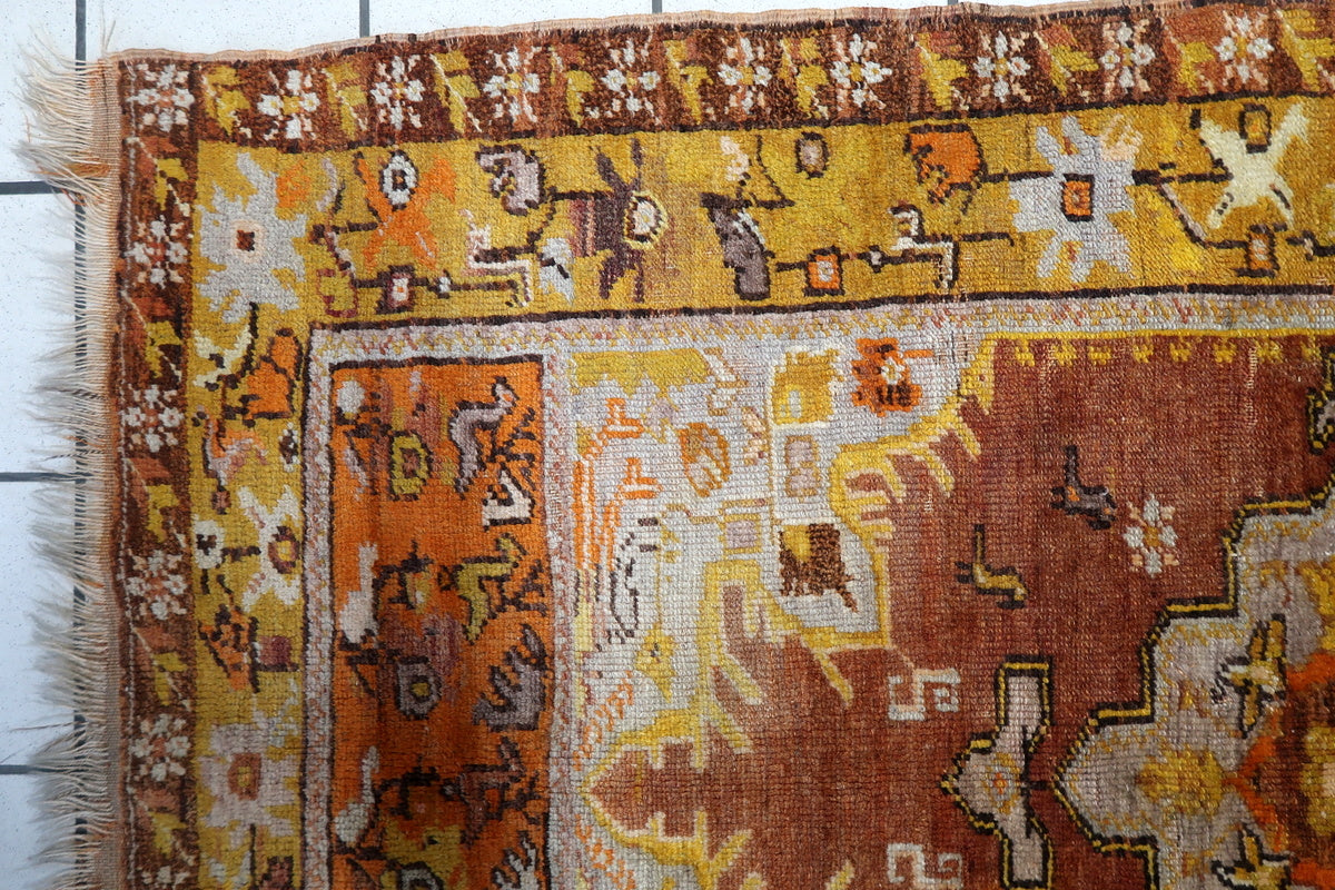 Aged patina highlighting the authenticity of this 1920s Anatolian rug
