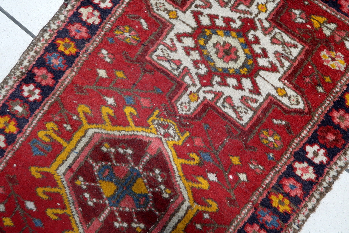 Vintage character shown through areas of low pile, adding to the rug's authenticity.
