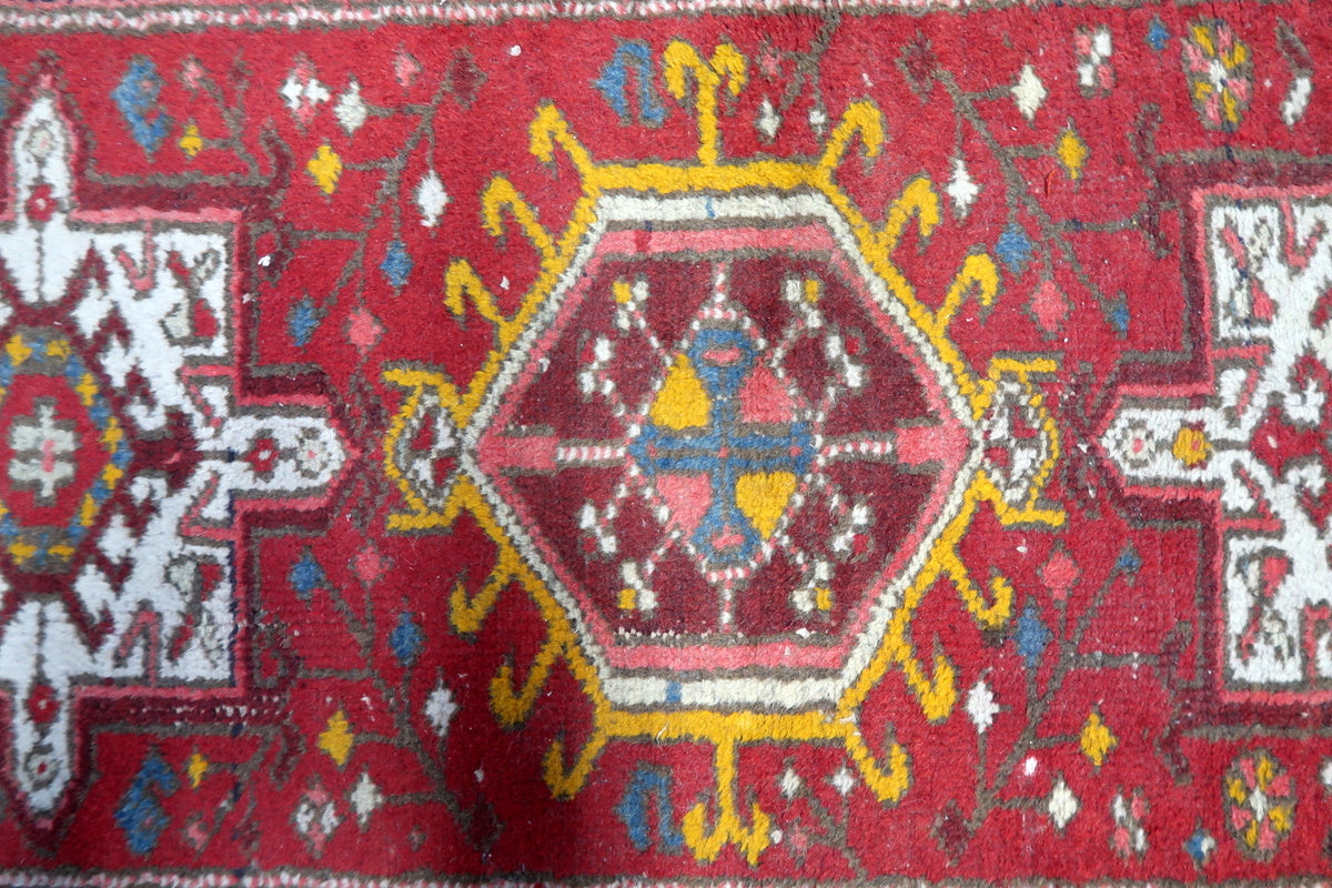 Close-up of the traditional tribal patterns and central medallions of the Karajeh rug.
