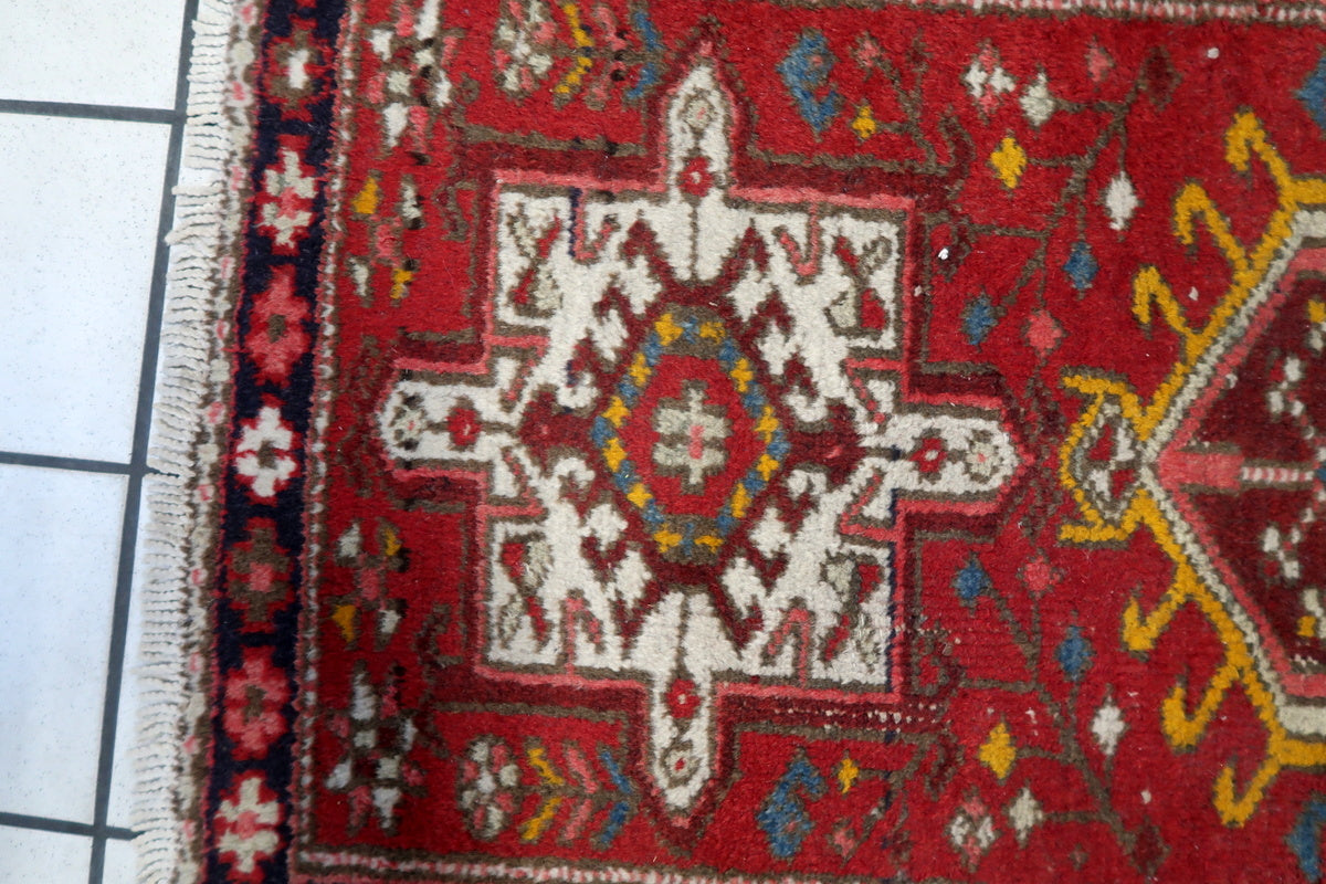 The rug folded to show the woven texture and fringed edges.
