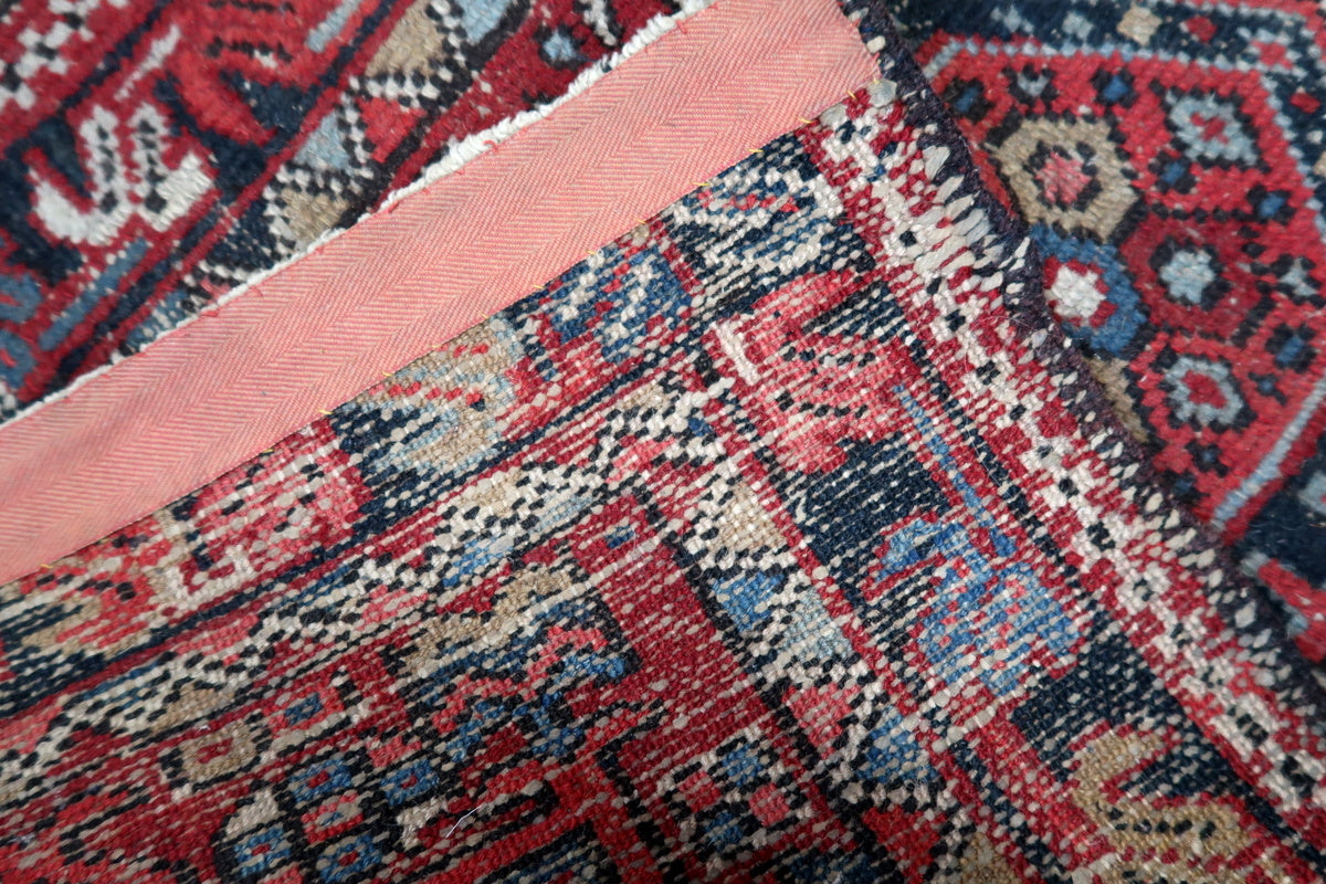 Persian Karajeh rug folded to reveal the craftsmanship of its woven backside
