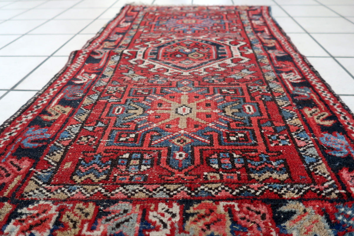 Small Persian accent rug with a striking red and blue pattern, perfect for home decor
