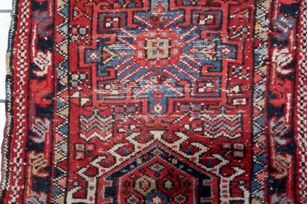 Detailed view of the aged wool texture and natural wear of the 1910s Karajeh rug
