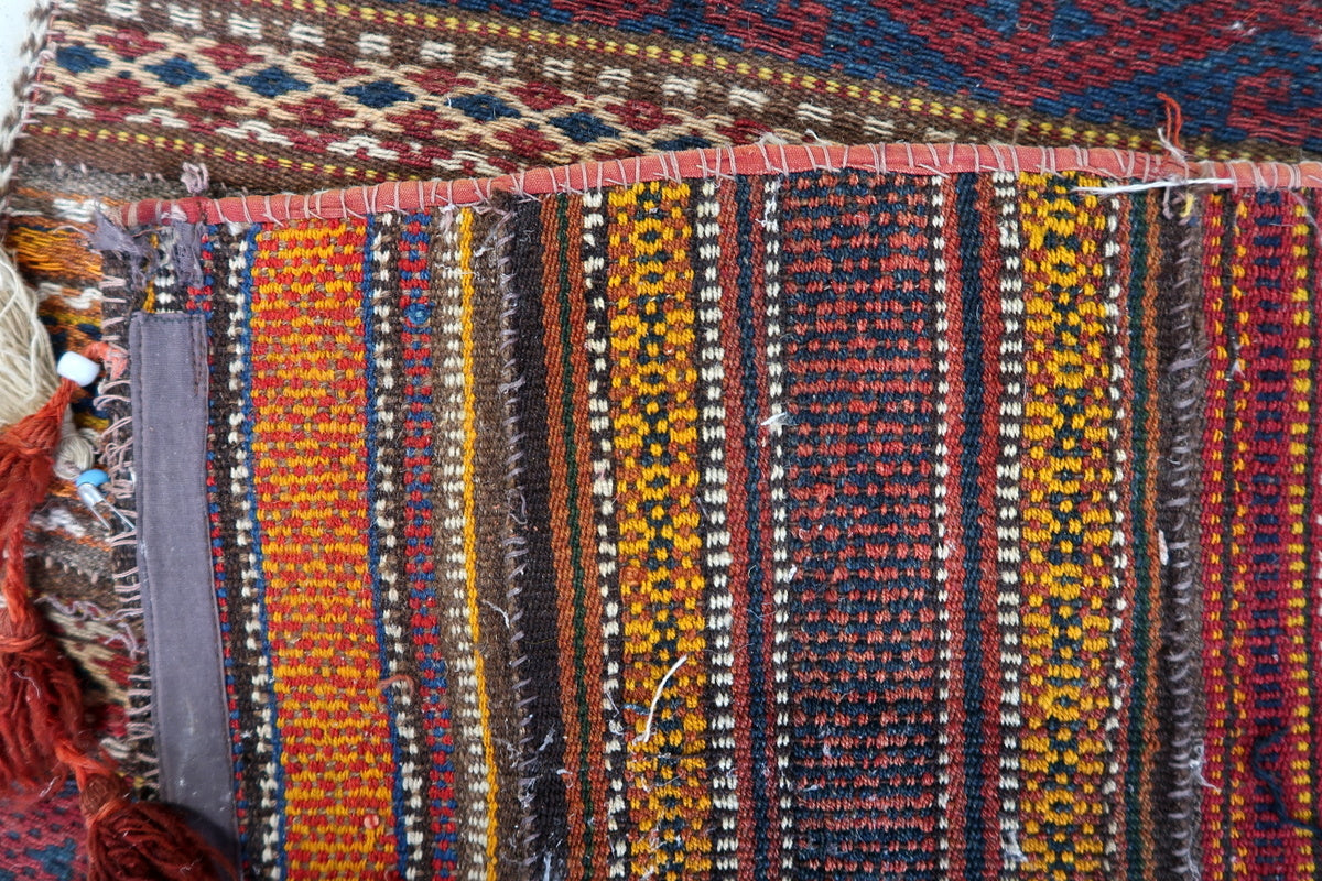 Geometric diamond designs in an antique Moroccan rug, representing Amazigh symbolism
