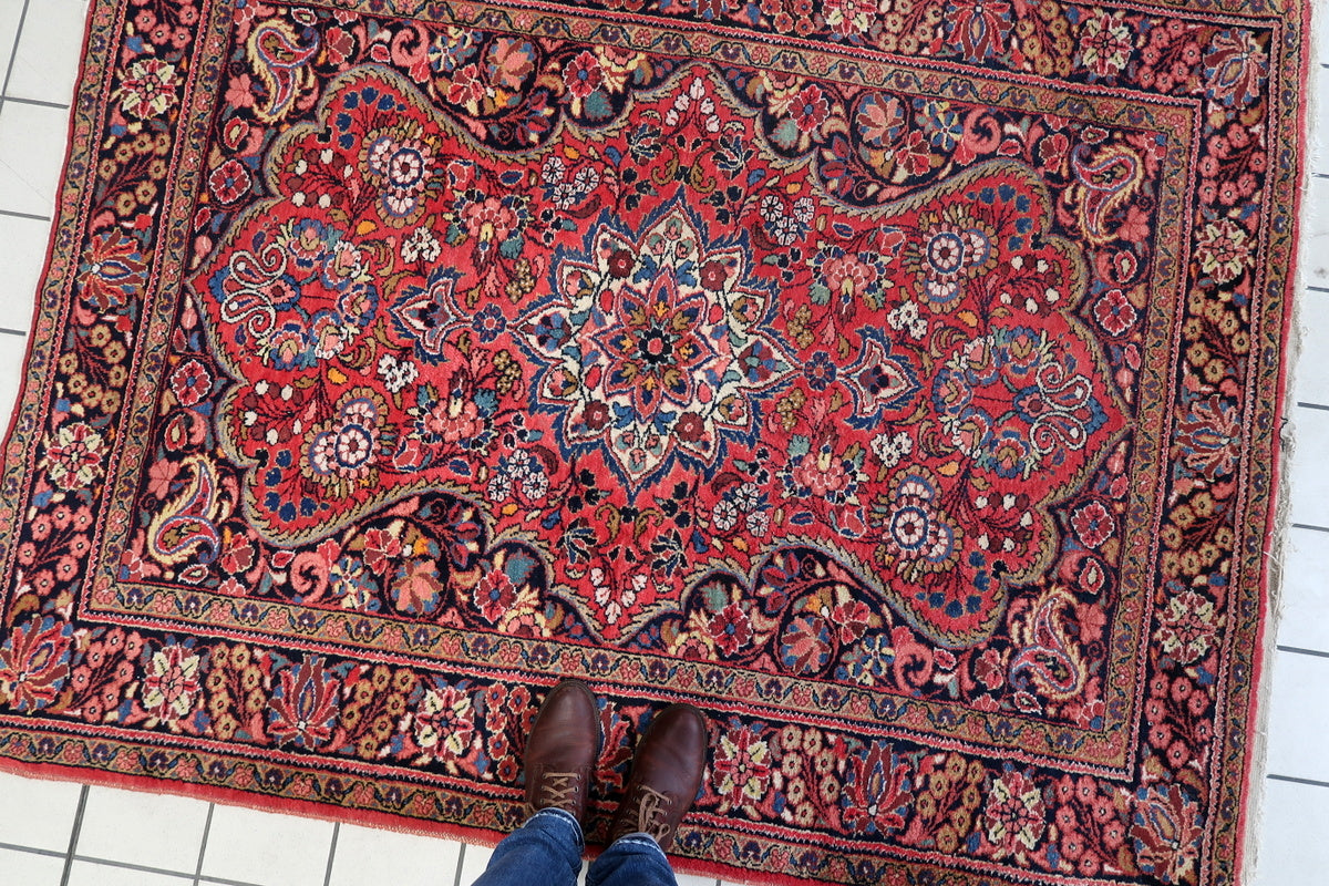 The rug folded to reveal the back, emphasizing the handmade craftsmanship
