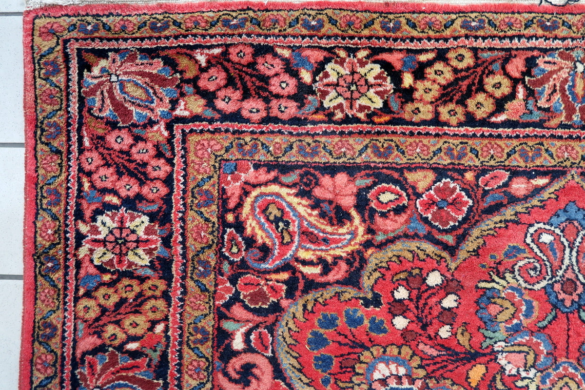 Full view of the antique Persian Mashhad rug showcasing its rich colors
