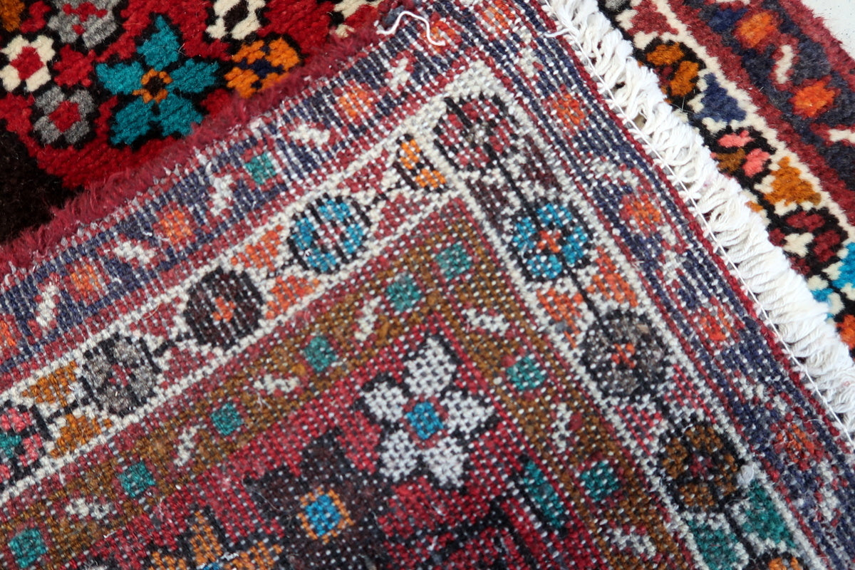 Intricate details of a Persian Hamadan rug with natural wool texture
