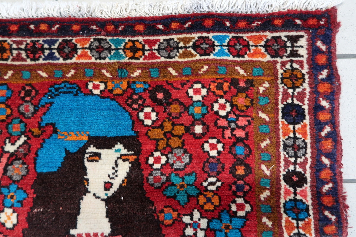 Vintage Persian rug with intricate floral motifs and bold colors
