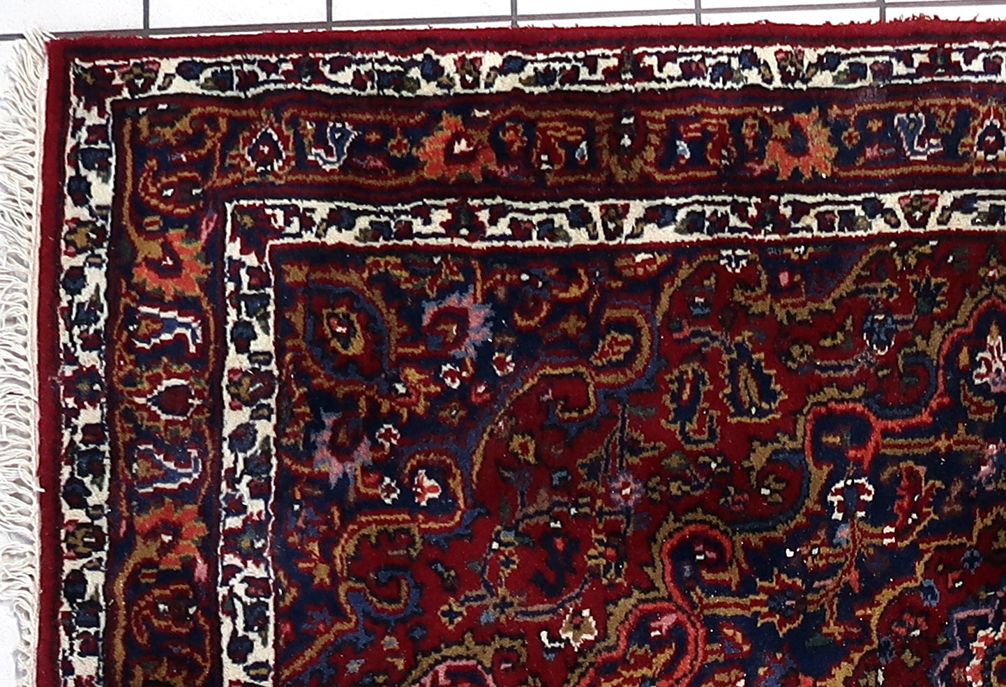 Close-up of intricate floral and geometric patterns on Hamadan rug
