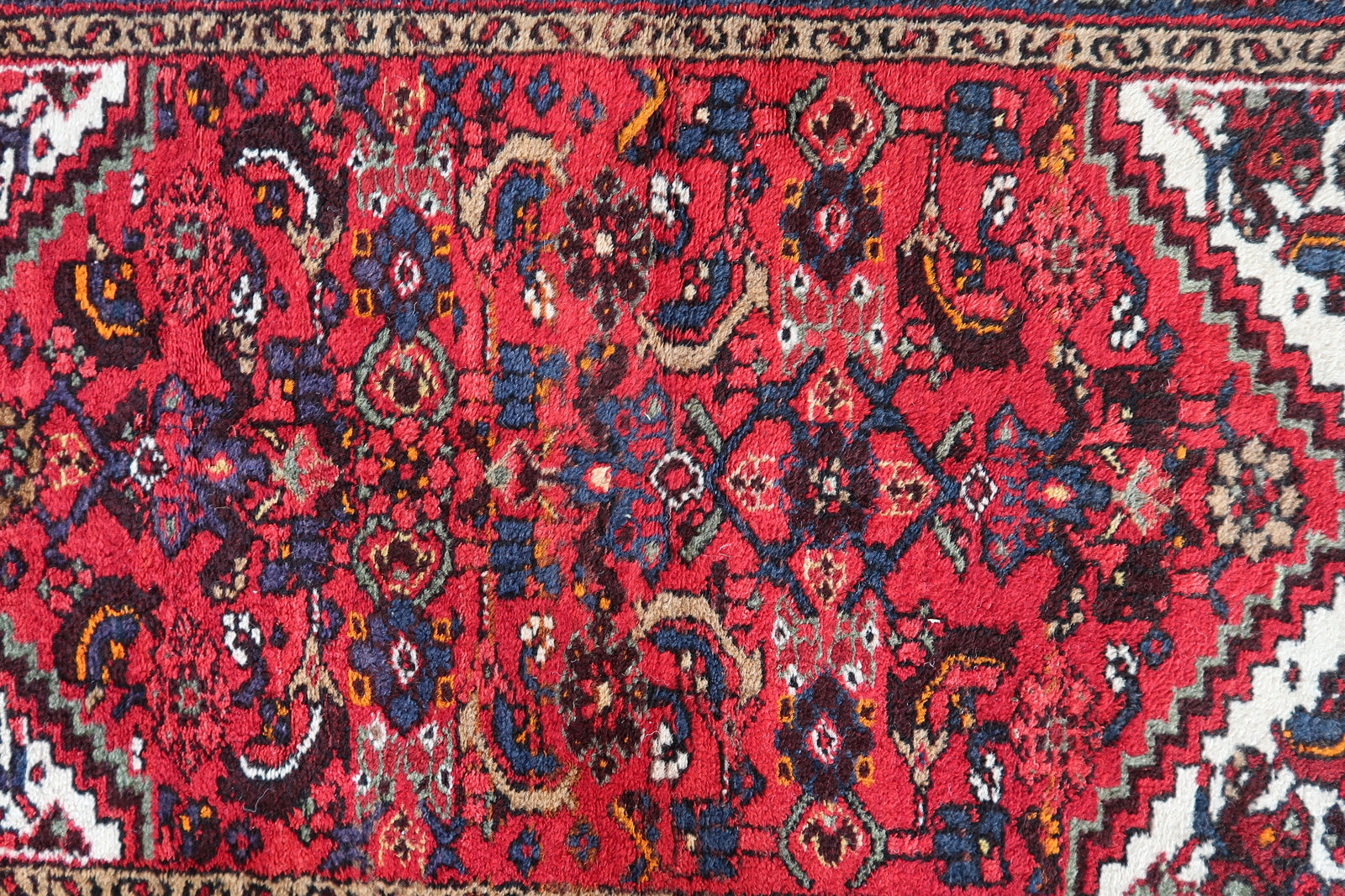 1970s Persian Hamadan rug with rich red field and navy blue border
