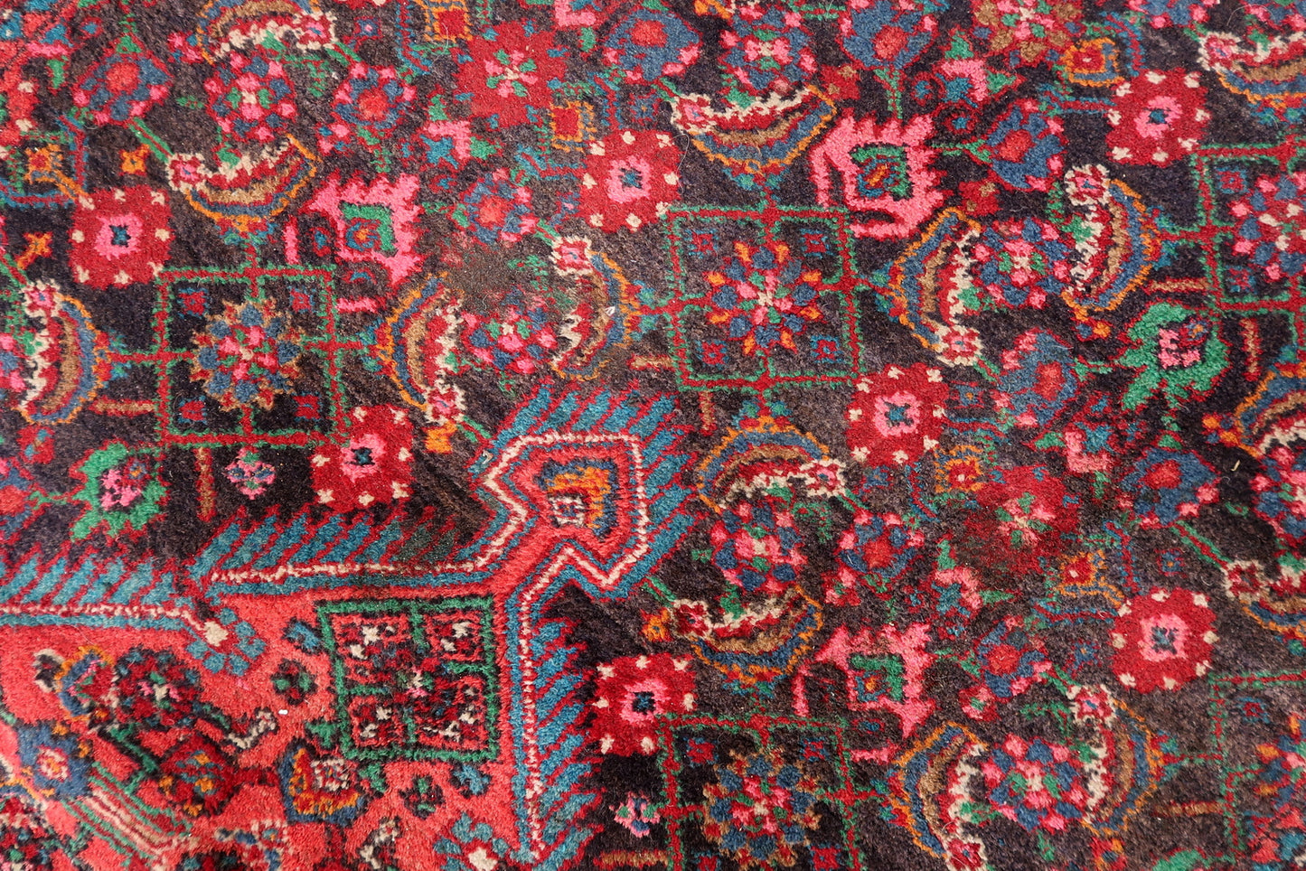 Handwoven Persian rug with traditional medallion design
