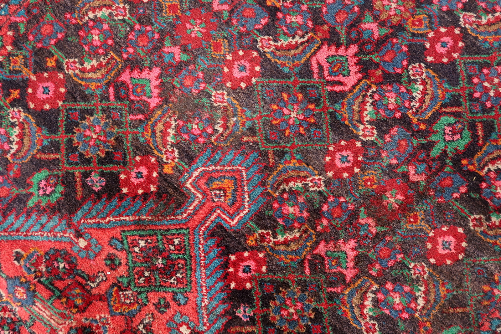 Handwoven Persian rug with traditional medallion design
