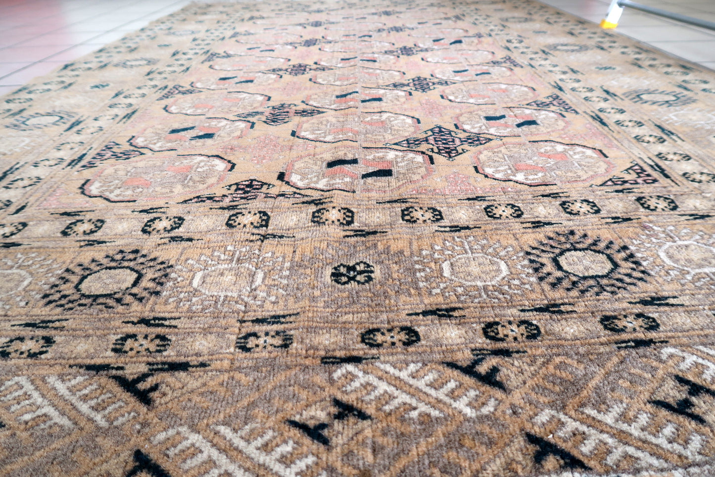 Detailed view of geometric patterns on vintage Afghan rug
