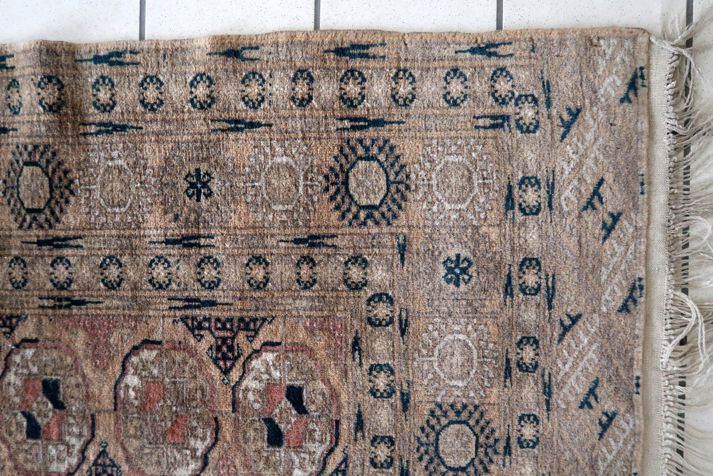 Reddish-brown Afghan rug with oval geometric patterns
