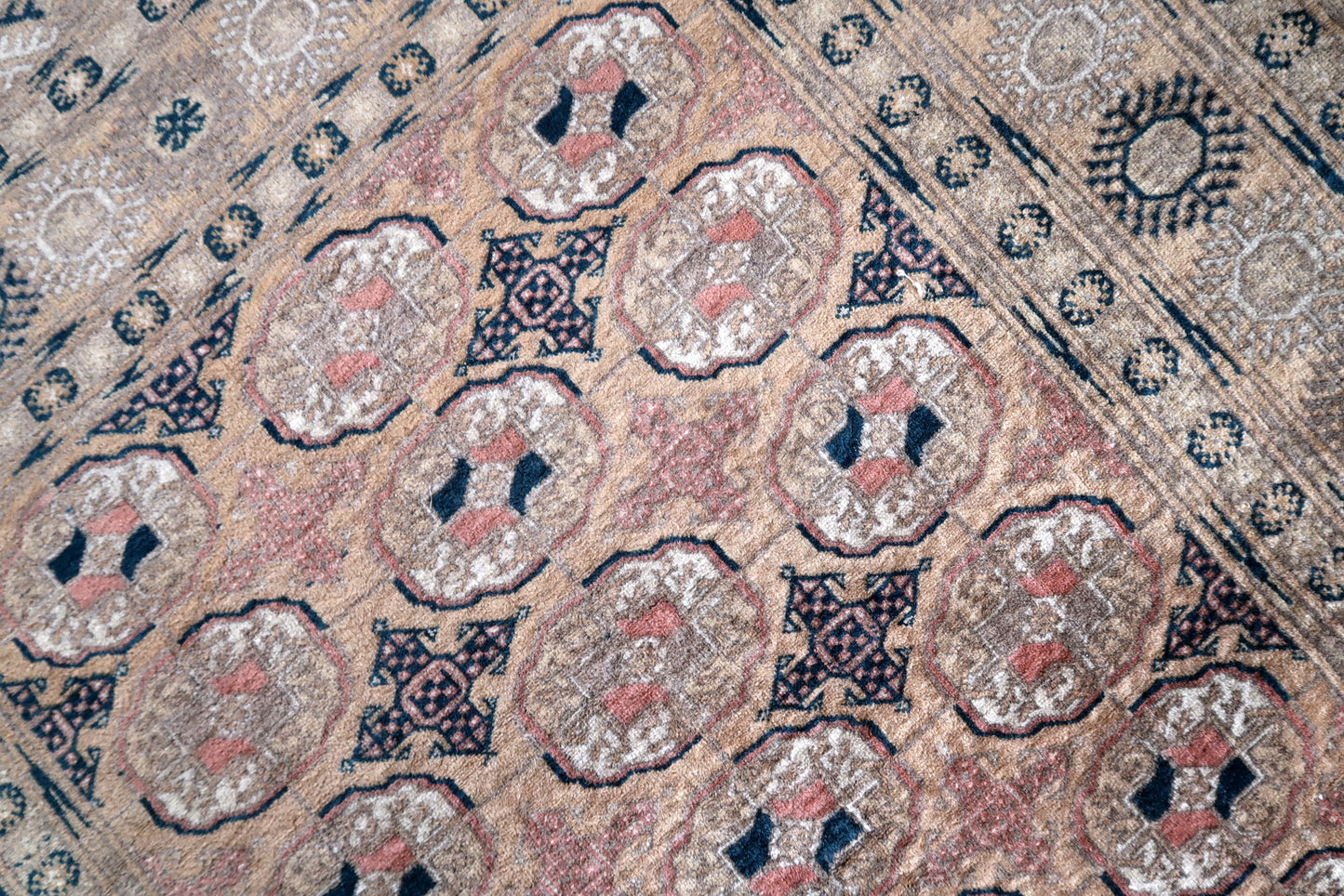 Close-up of vintage Afghan rug showing geometric patterns
