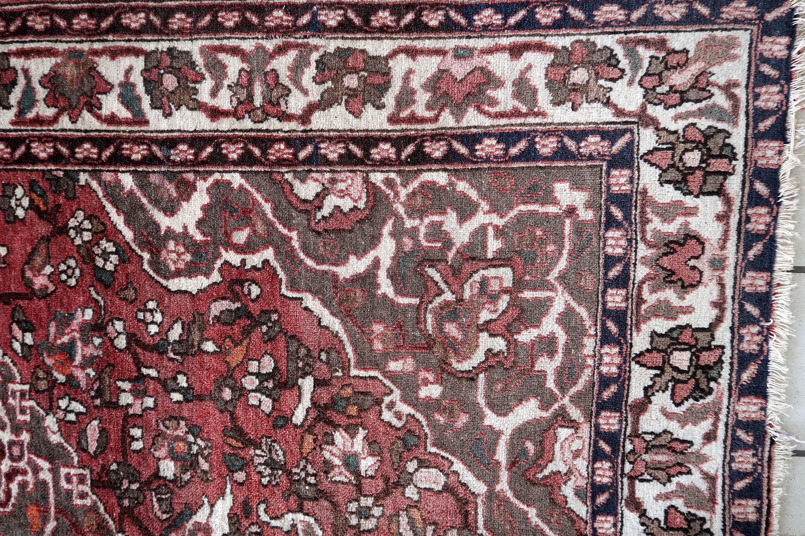 1960s Persian wool rug with floral motifs
