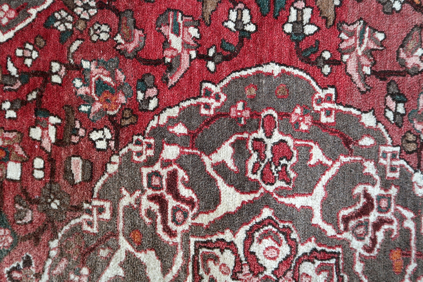 Vintage Persian carpet with worn edges
