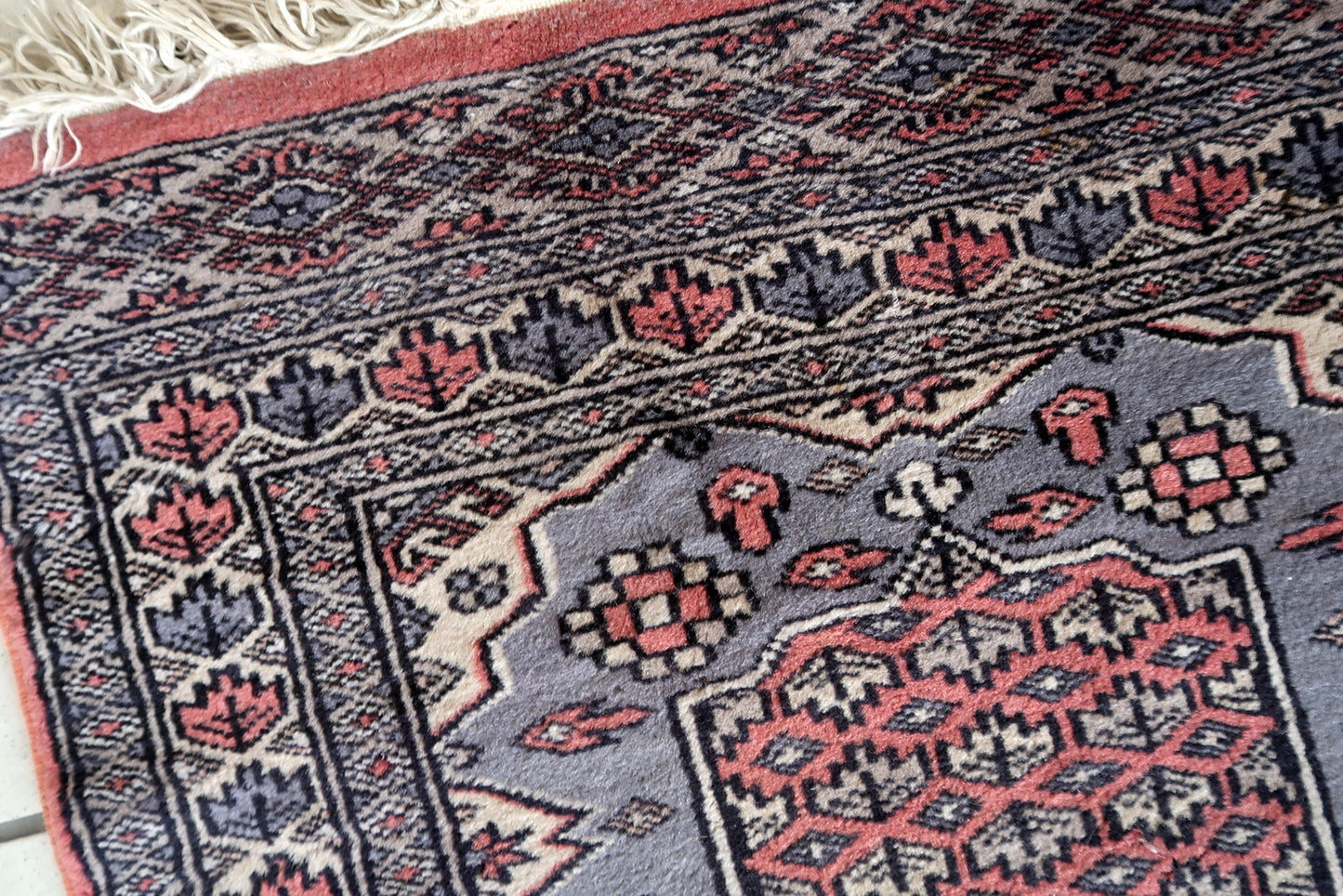 Intricate rectangular Bukhara rug design
