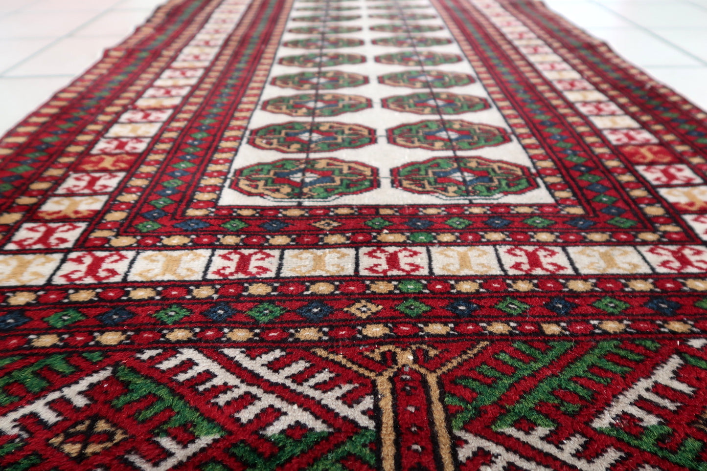 Vibrant red and green Bukhara rug
