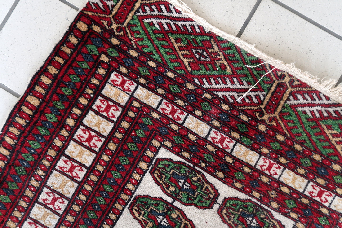 Red, green, and white Bukhara rug
