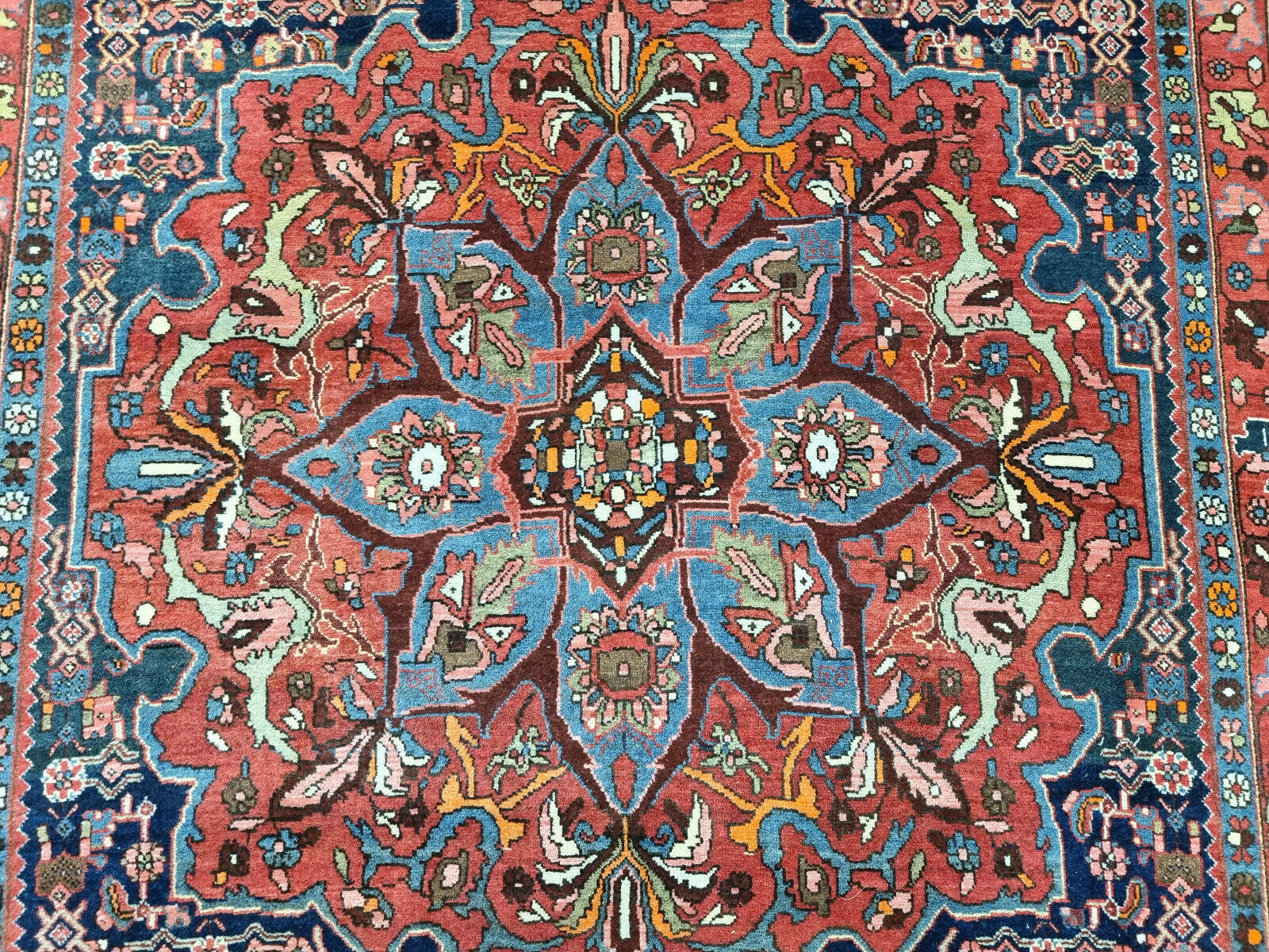 Detailed floral patterns on the border of the antique rug
