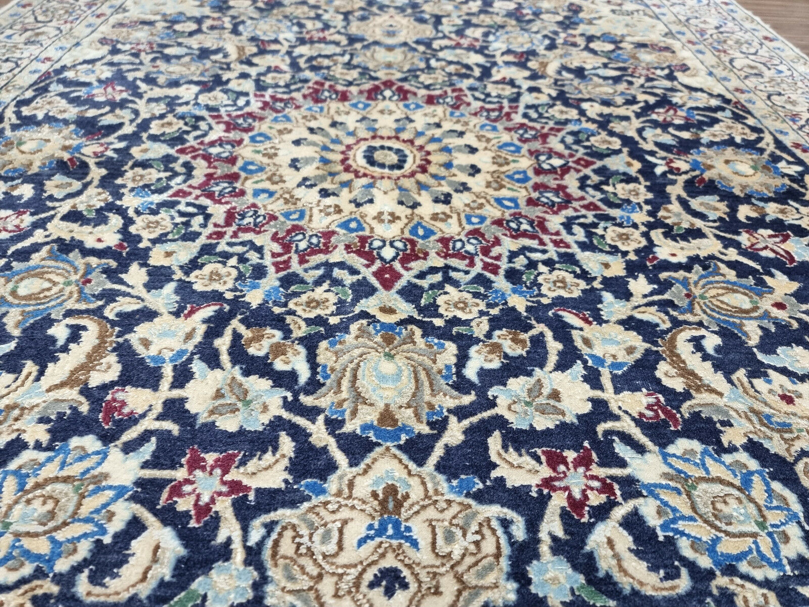 Central medallion design of the Nain rug with intricate floral motifs
