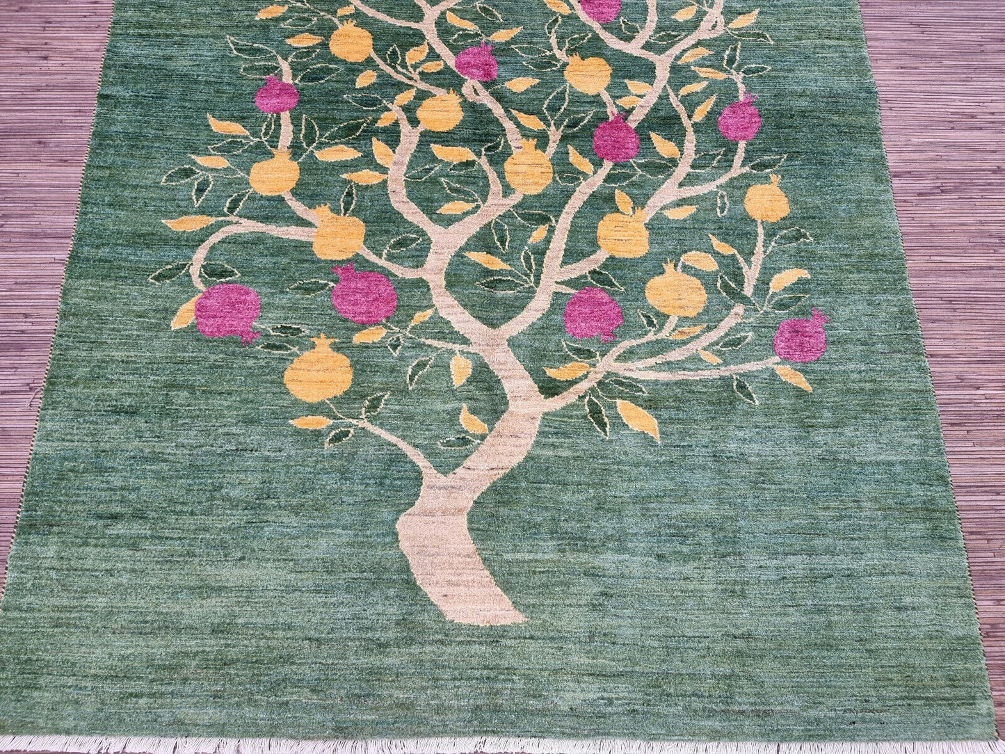 Symmetrical tree pattern on the green background of the rug
