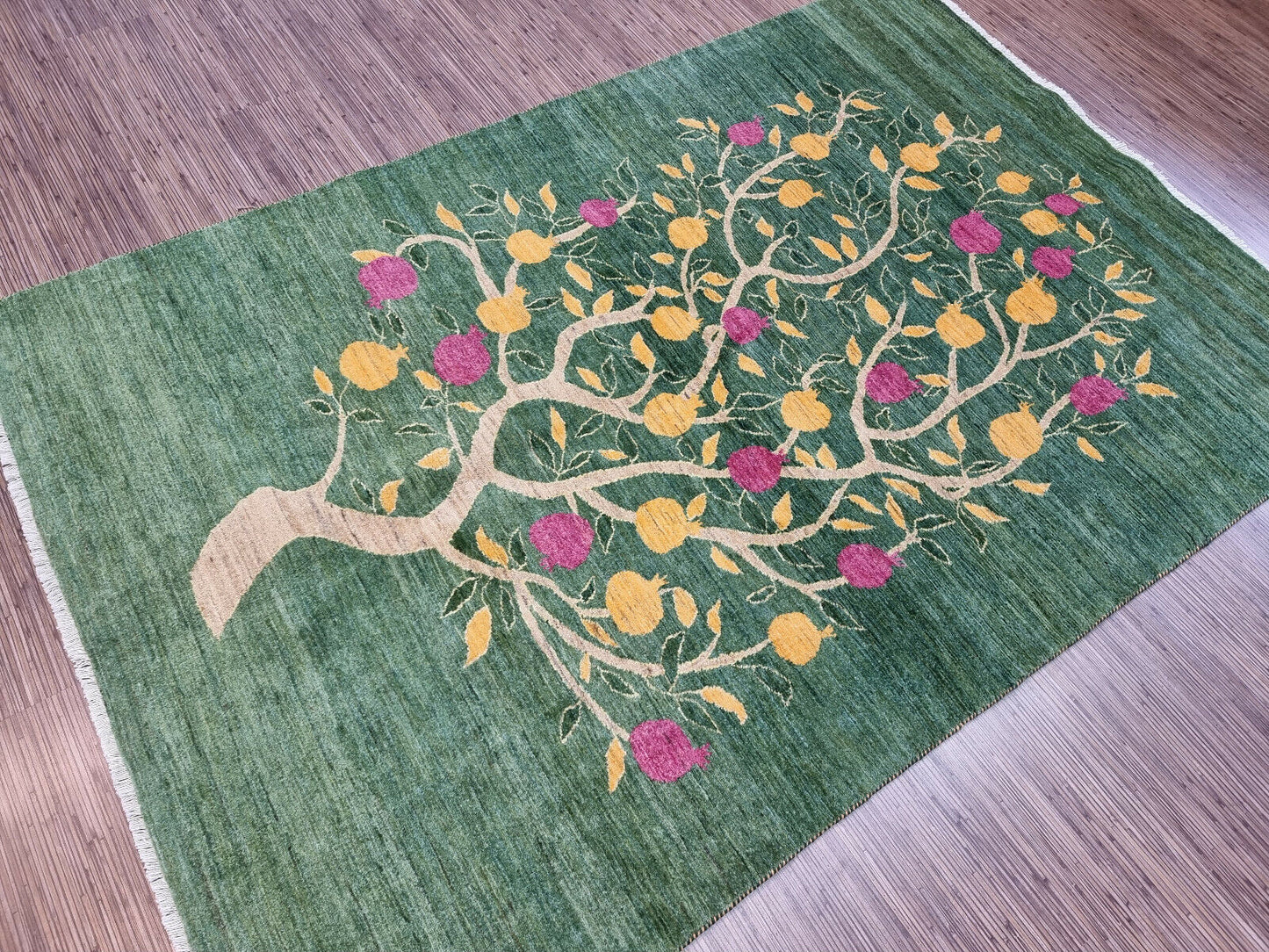 Green background and beige branches on the Persian Gabbeh rug
