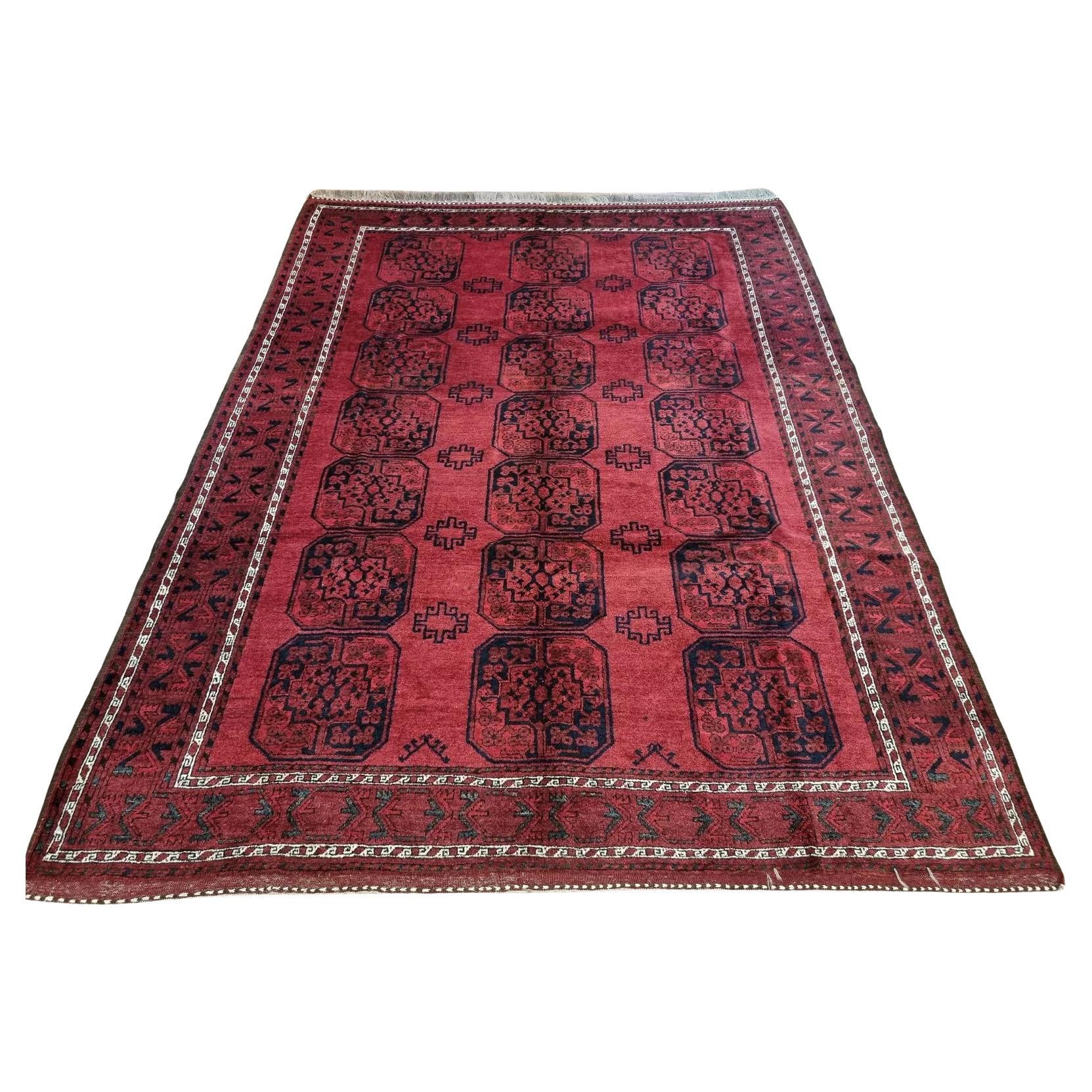 Antique Afghan Ersari carpet with traditional red design
