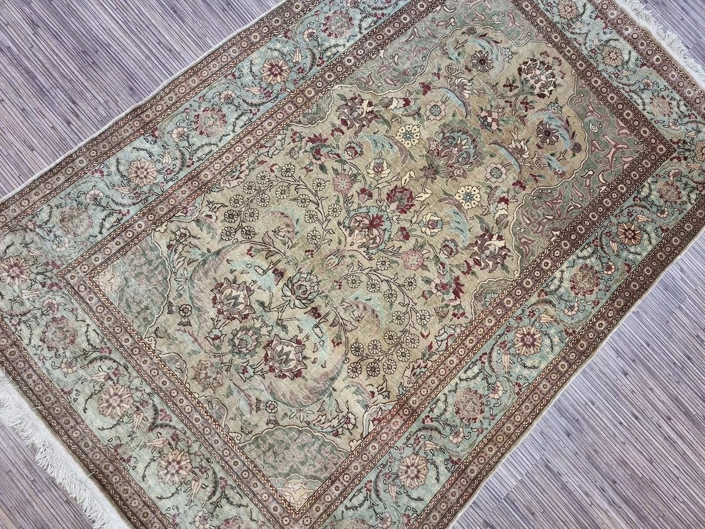 Soft and luminous texture of the 100% silk Hereke prayer carpet
