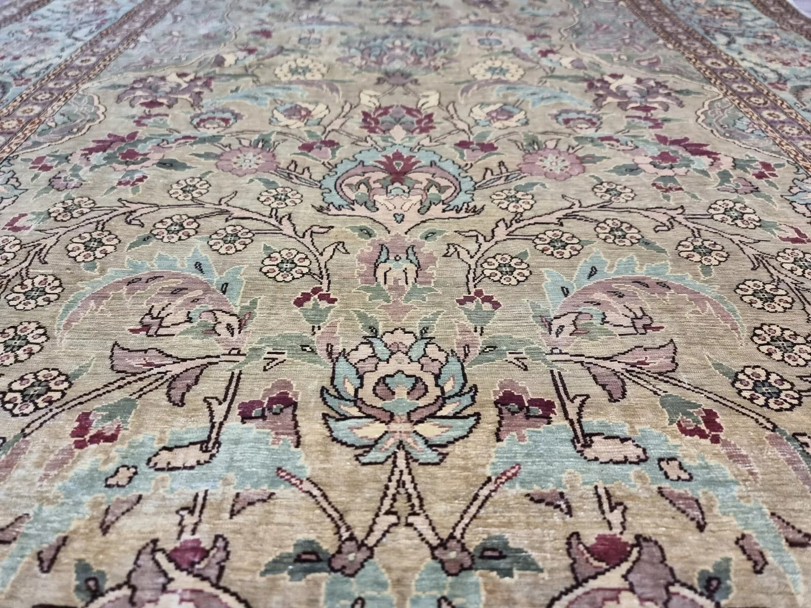 Soft and luminous texture of the 100% silk Hereke prayer carpet
