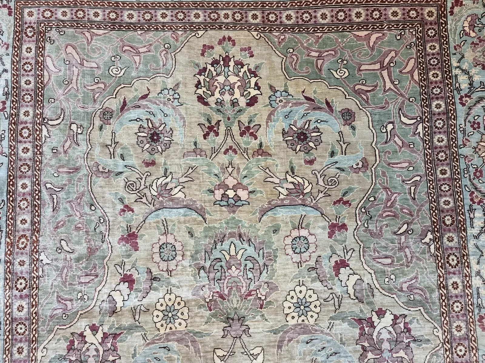 Vintage Turkish Hereke silk prayer rug with intricate floral patterns and a turquoise border
