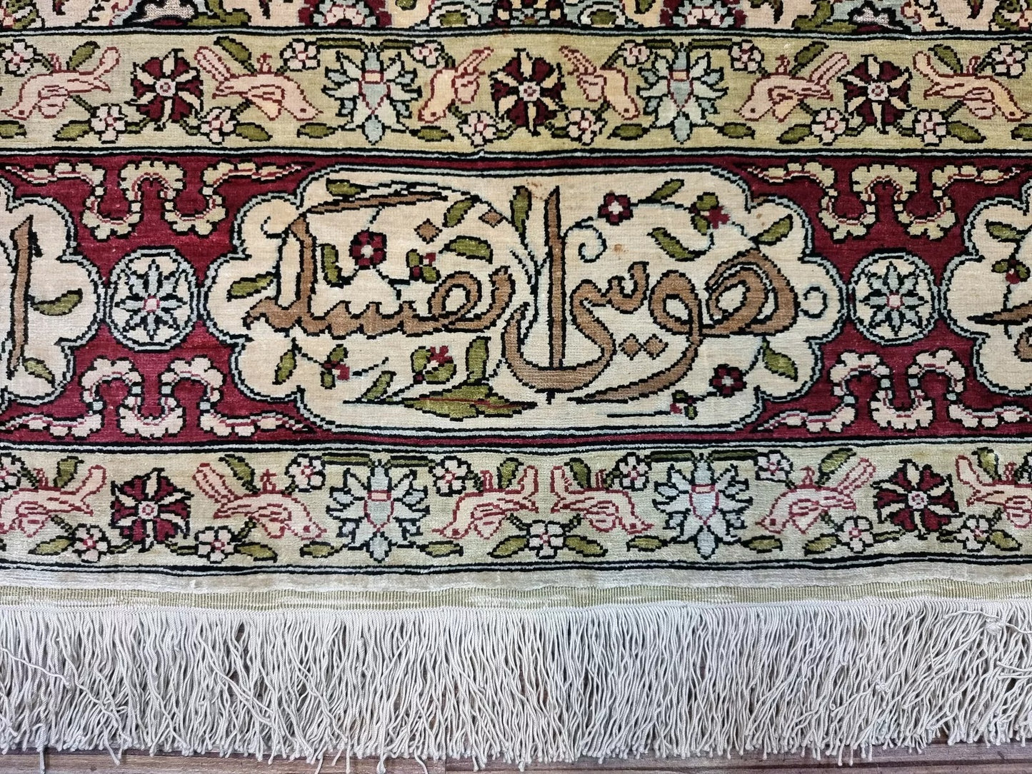 Close-up of the intricate floral design on a 1960s Hereke hand-knotted silk rug
