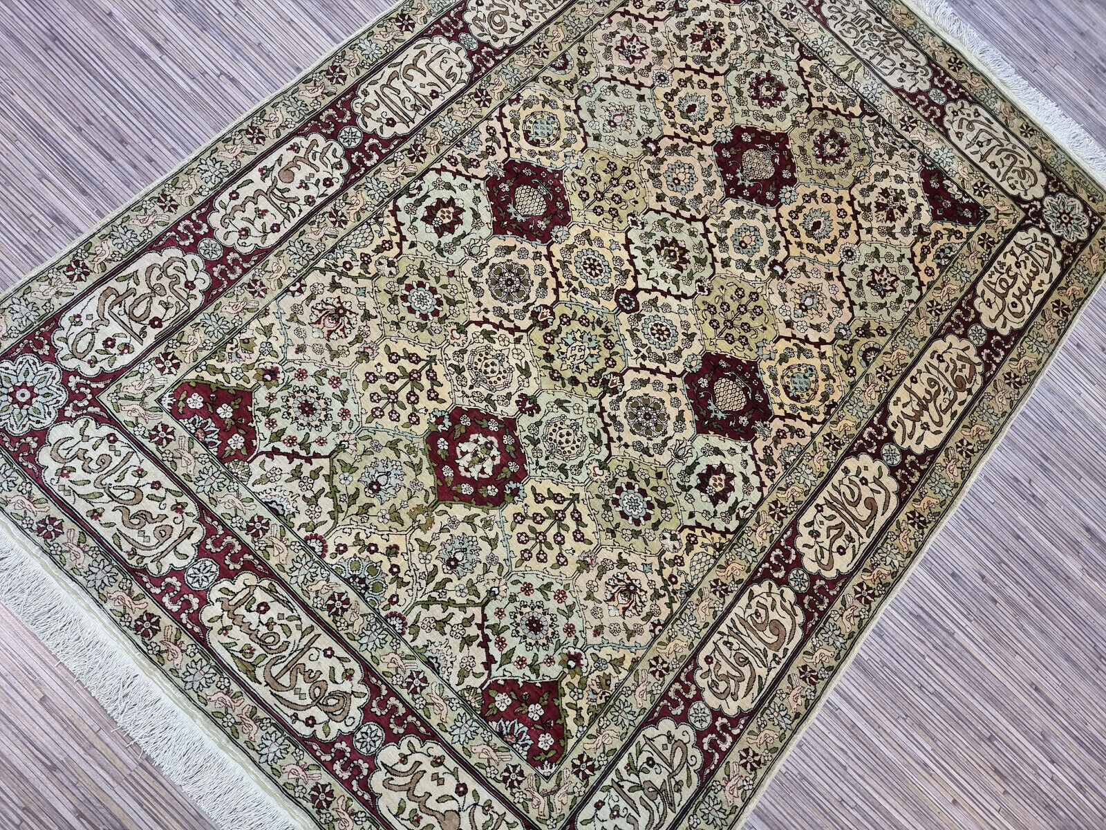 Full view of the rectangular Hereke silk rug showcasing its luminous texture
