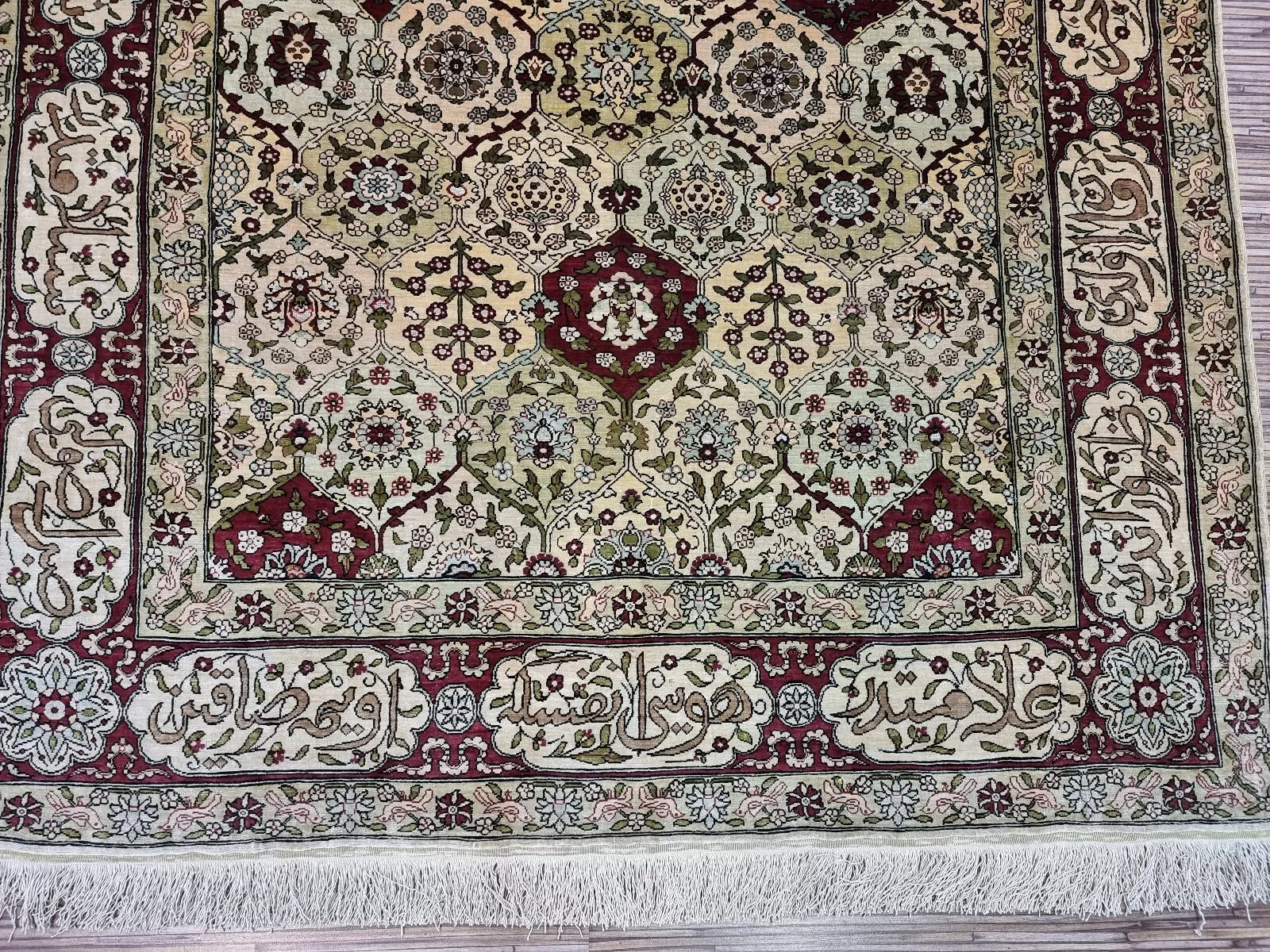 Detailed calligraphy-inspired border design on the vintage Turkish rug
