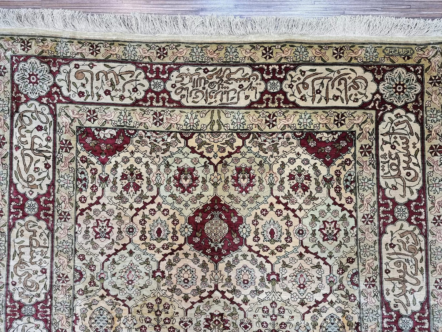 Elegant floral centerpiece of the 1960s Hereke silk rug
