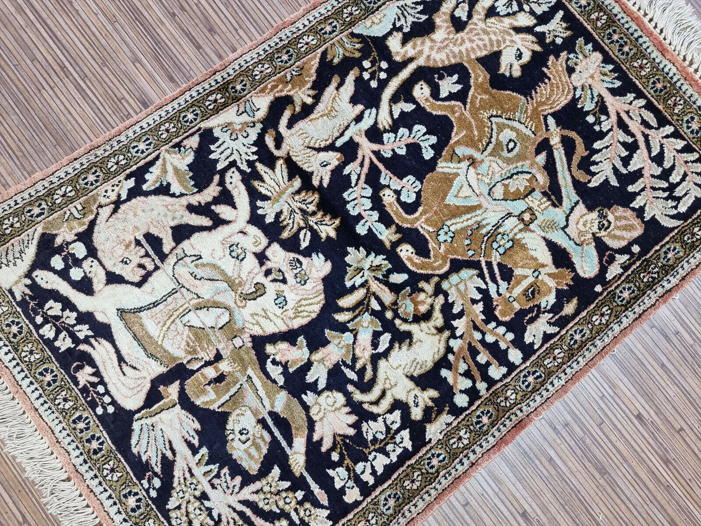 Detailed floral border surrounding the vintage Qum silk rug
