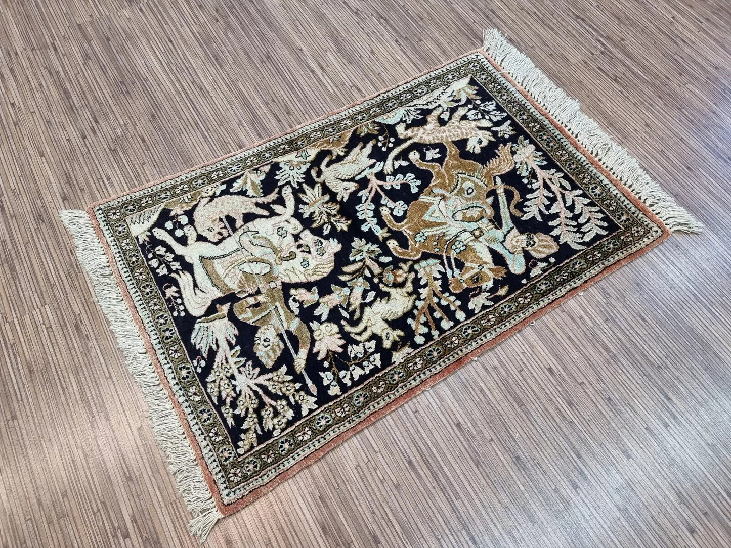 Lustrous 100% silk texture of the Persian Qum-style rug under light
