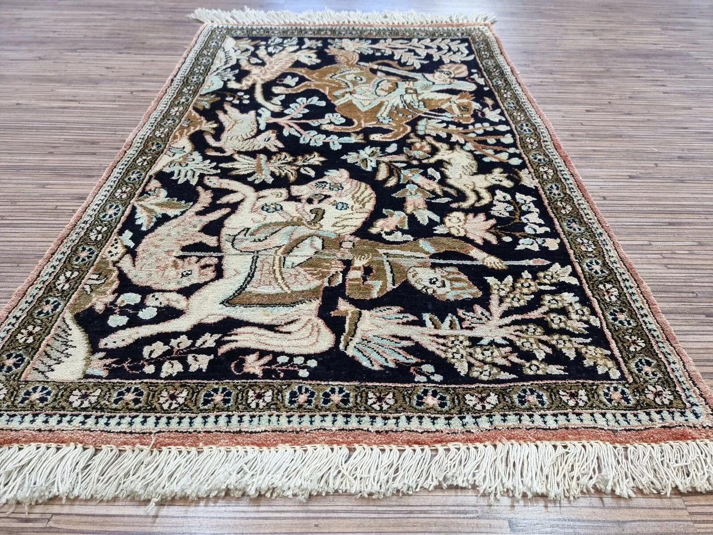 Rectangular Oriental Qum silk rug with detailed hunting and floral designs
