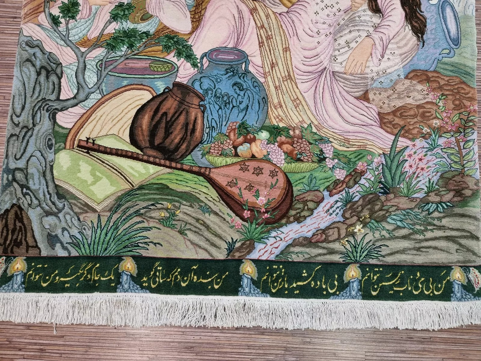 Close-up of figures depicted on a Persian Tabriz silk rug.
