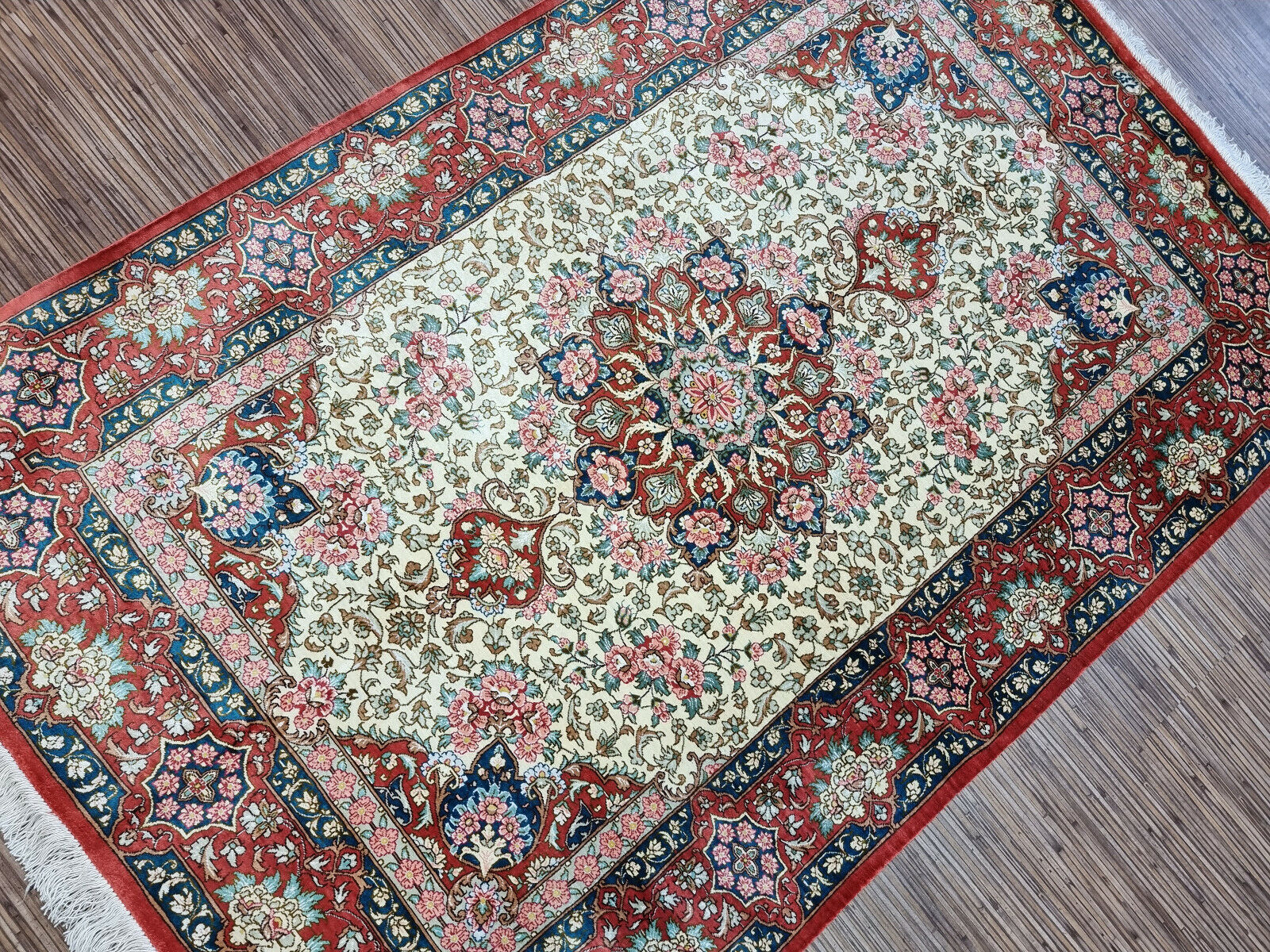 Rectangular 1990s Persian silk rug with a rich floral border.
